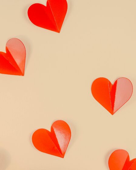 Red-Paper-Hearts-on-Beige-Background